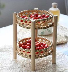 two baskets with tomatoes in them sitting on a table