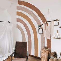 a living room with a chair and wall hangings