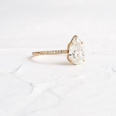 a gold ring with an oval cut diamond