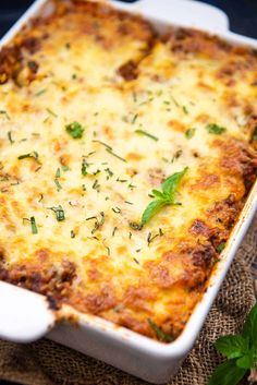 a casserole dish with cheese and herbs