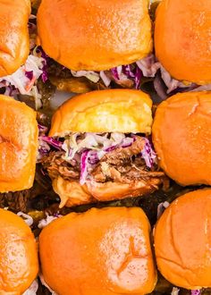 several pulled pork sliders with coleslaw and cheese on the side, top view