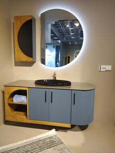 a bathroom with a sink, mirror and rug on the floor in front of it