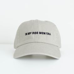 a white hat with the words in my dog mom era embroidered on it's front