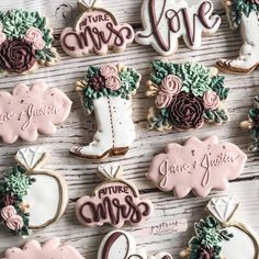 decorated cookies are arranged on a table with the words, time for love and boots