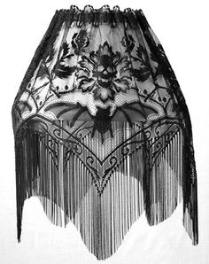 an old fashion skirt with fringes and flowers on the bottom, in black and white