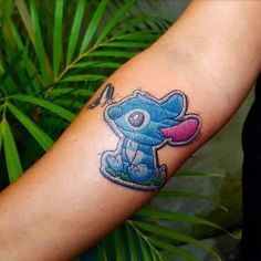 a person with a tattoo on their arm that has an image of a cartoon character on it