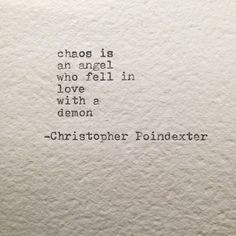 a quote written on the side of a white wall with blue writing that says chaos is an angel who fell in love with a demon