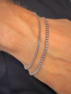 Elevate your style with our men's silver-tone stainless steel chain bracelet. Crafted from durable stainless steel, this bracelet is resistant to corrosion and tarnish, ensuring long-lasting shine and reliability. Features: - Material: Stainless Steel - Color: Silver-Tone - Sizes: Available in various lengths for a perfect fit This bracelet is perfect for both everyday wear and special occasions, easily pairing with other accessories and jewelry. The secure clasp ensures comfort and safety. Add Silver Tennis Bracelet With Round Chain, Silver Tennis Bracelet With Chain Link, Silver Chain Link Jubilee Tennis Bracelet, Silver Tarnish-resistant Bangle Chain Bracelet, Silver Tarnish-resistant Chain Bangle, Silver Cuban Link Bracelet, Tarnish Resistant For Everyday, Durable Silver Stainless Steel Chain Bracelet, Silver Tarnish Resistant Cuban Link Bracelet For Everyday, Silver Tarnish-resistant Cuban Link Bracelet For Everyday