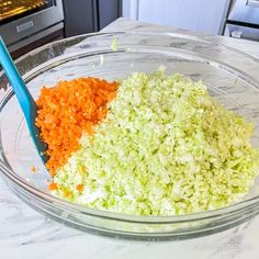 chopped vegetables in a glass bowl with a blue plastic spoon sitting on top of it