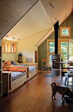 a dog is standing in the middle of a room with wood floors and an open fireplace