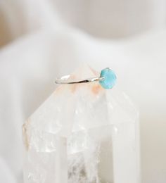 This petite yet dazzling ring, made of sterling silver, displays a beautiful slice of genuine Larimar. Regardless of your personal style, every gem boasts their own individual shape, making them just as exceptional as you. Each stone ranges in a mix of aqua blue and white. Larimar Meaning: Exclusive to the Dominican Republic, Larimar is a rare blue form of Pectolite. The man who coined the name Larimar, named it after his daughter, taking part of her name (Larissa) and the Spanish word for sea ( Larimar Ring, Larimar Rings, Spanish Words, The Dominican Republic, Crystal Rings, Dominican Republic, Aqua Blue, Gift Necklace, Handmade Silver