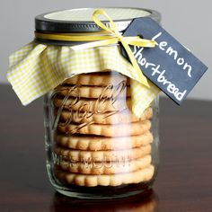 a jar filled with cookies sitting on top of a wooden table