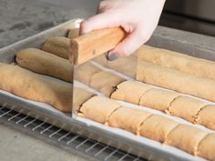 a person is rolling dough on a baking sheet