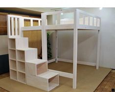 there is a bunk bed with stairs built into it in the room that's made out of plywood