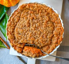 a close up of a pie on a plate with a spoon