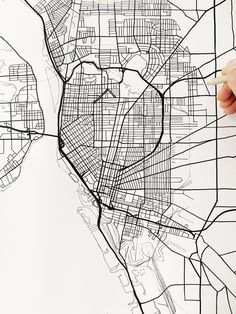 a hand drawing a map of the city