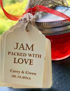 two tags with the names jam packed with love on them sitting next to a jar of jam