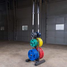 an assortment of colorful pulleys in a large garage with two overhead storage doors