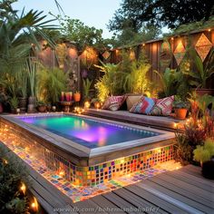 an outdoor swimming pool surrounded by plants and lights