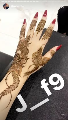 a woman's hand with henna tattoos on it, and the number 9