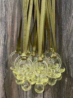 a bunch of wine glasses hanging from a wooden wall next to a pair of scissors