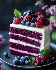 a slice of red, white and blue cake with berries on top is sitting on a plate