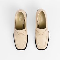 A flared loafer in creamy calf leather. The high contrast, triple-layered welt gives height and stability. Wear it with an ankle sock for a preppy come retro vibe. Classic Slip-on Moccasins With Lug Sole, Slip-on Platform Loafers With Contrast Sole For Workwear, Classic Beige Slip-ons For Office, Classic Low Heel Slip-ons For Workwear, Classic Cream Slip-on Moccasins, Classic Leather Slip-ons With Lug Sole, Classic Beige Slip-ons For Fall, Business Almond Toe Platform Loafers With Stitched Sole, Low Heel Loafers With Rubber Sole For Work