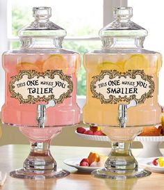 two glass jars with labels on them sitting on a table next to plates and bowls