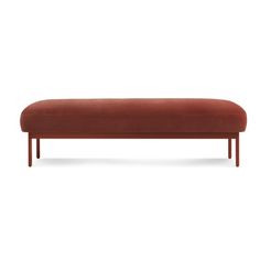 an orange bench with wooden legs and a long cushion on the bottom, against a white background