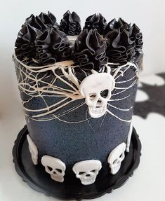 a black and white decorated cake with skulls on it