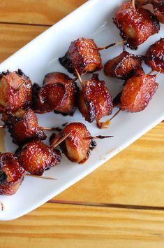 bacon wrapped in toothpicks on a white plate