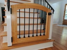 a wooden stair case with metal railings in a house