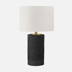 a black table lamp with a white shade