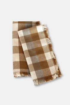 two brown and white checkered scarves sitting on top of each other