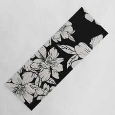 a black and white flowered design on the side of a piece of paper that is folded in half