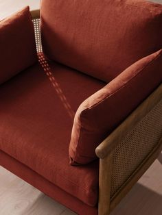 a red chair sitting on top of a hard wood floor