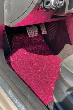 the interior of a car with pink glitter floor mats and steering wheel covers on it