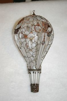 a glass hot air balloon hanging on the wall