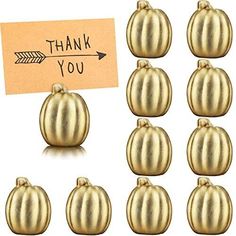 twelve gold pumpkins with thank you note attached to them