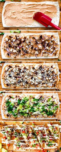 four hot dogs with different toppings on them sitting on top of a cutting board