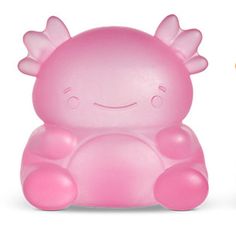 two little toys sitting next to each other on top of a white surface and one is pink