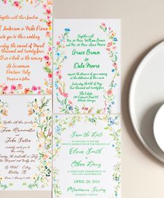 the wedding stationery is decorated with colorful flowers and greenery, along with a white plate