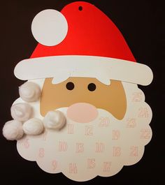 a clock with a santa claus face and white cotton balls on it's face