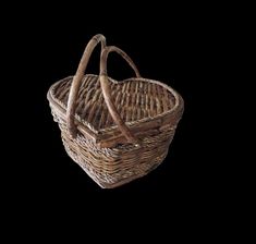 a brown wicker basket with two handles