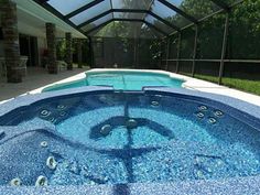 an indoor hot tub in the middle of a pool