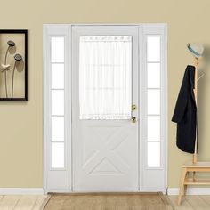 a white front door with curtains and a coat rack