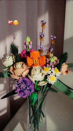 a vase filled with lots of colorful flowers