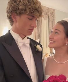 a young man and woman dressed in formal wear