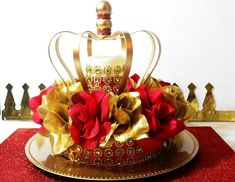 a gold crown cake with red roses on top