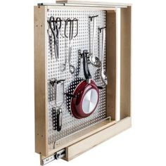 a wall mounted tool rack with hooks and pans